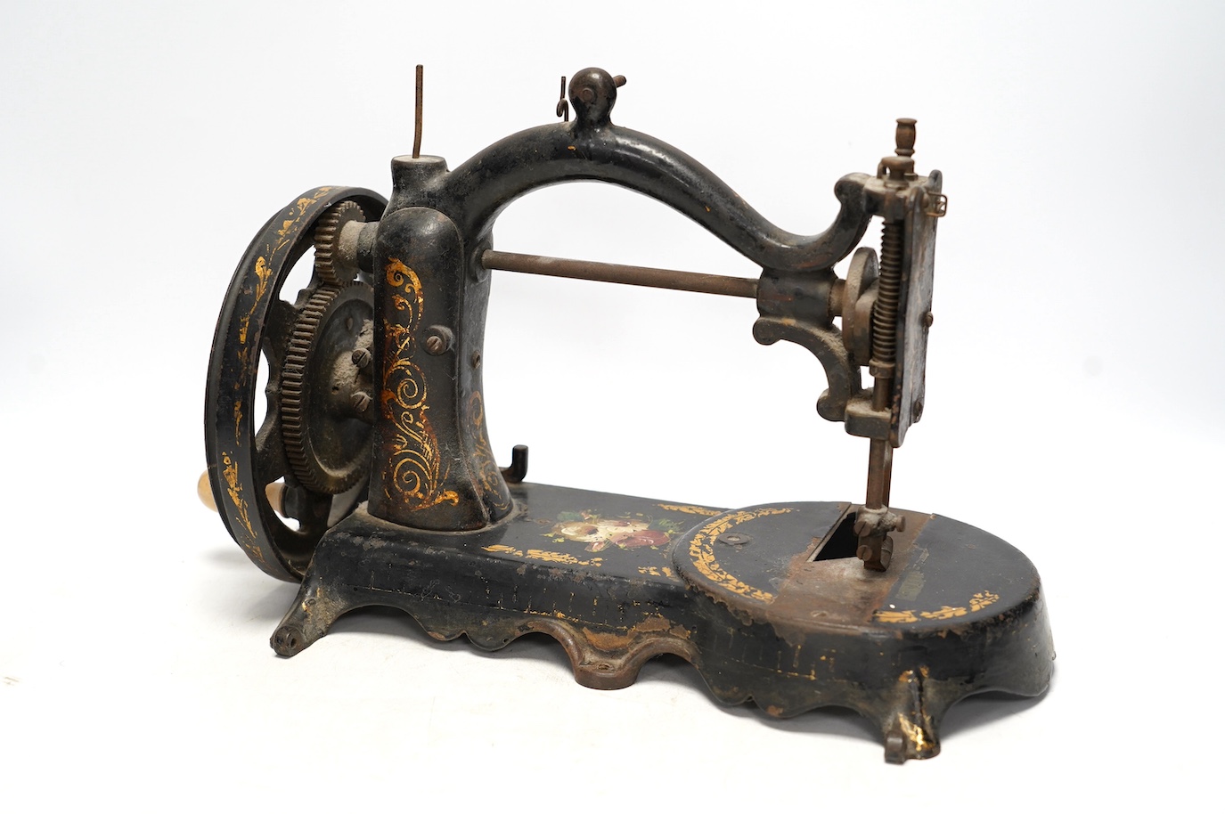 An unmarked late 19th century swan neck sewing machine, with cast iron base and gilt and floral decoration. Condition - fair